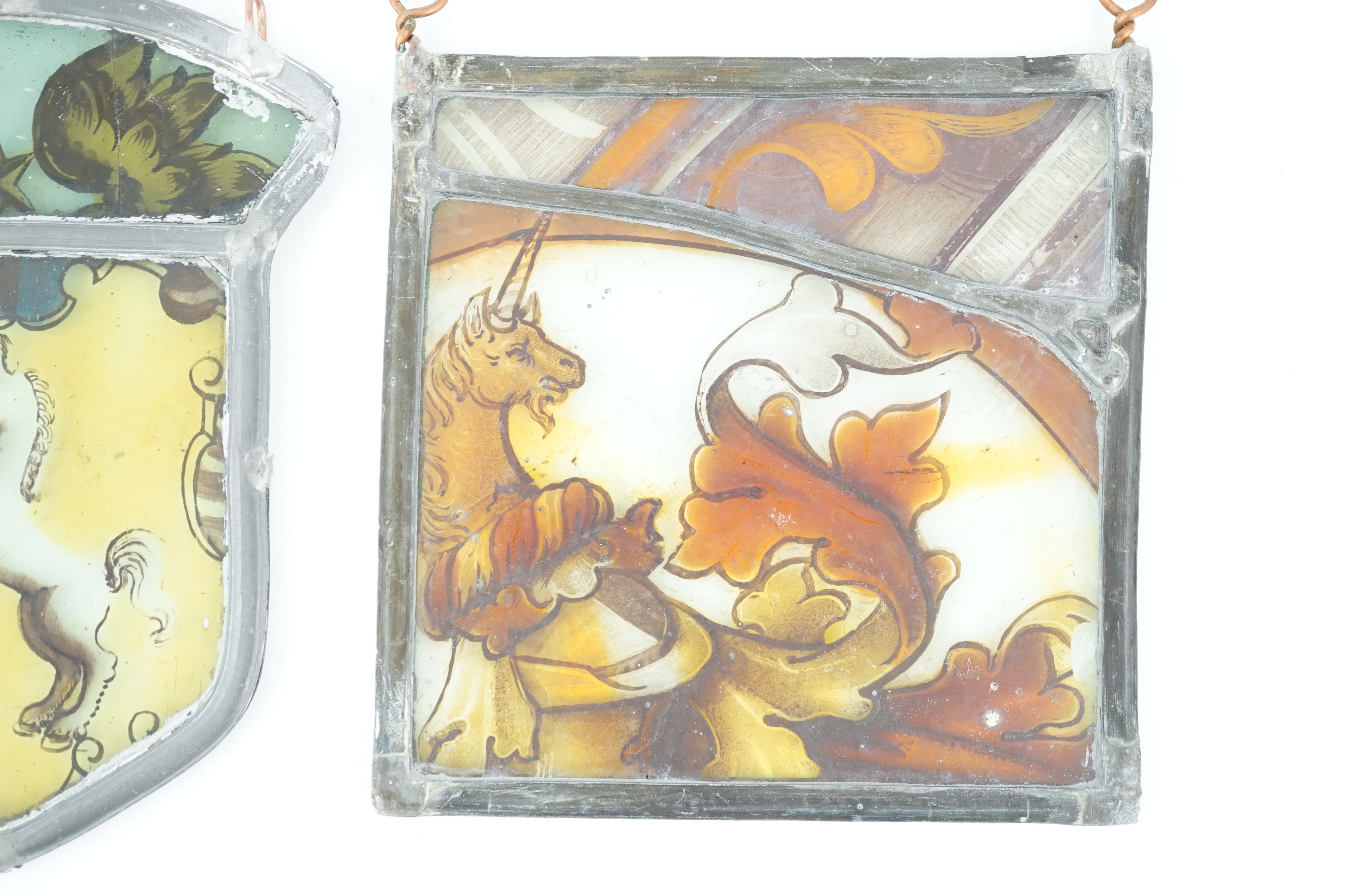 Two 17th century stained glass fragment panels, 13 x 12cm and 14 x 10cm